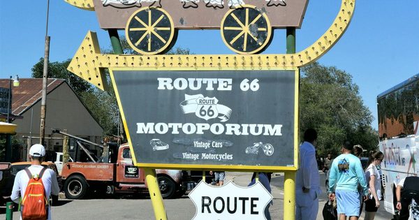 Real Route 66 storefront signage and vintage vehicles on the street in downtown Seligman, Arizona